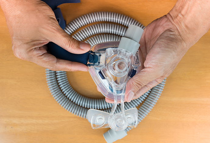 Pair of CPAP mask and tubing.<br />
Cleaning cpap mask and tubing is a routine job,selective focus on cpap mask,flat lay